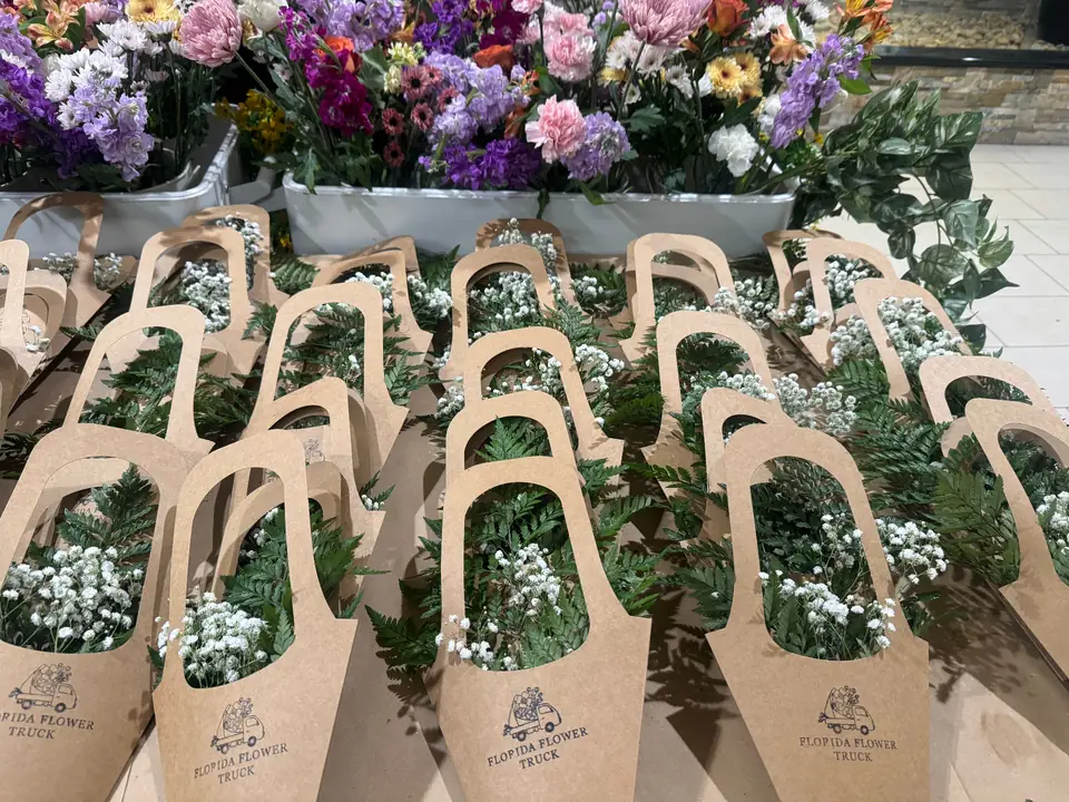 Kraft-wrapped bouquets lined up and ready for guests