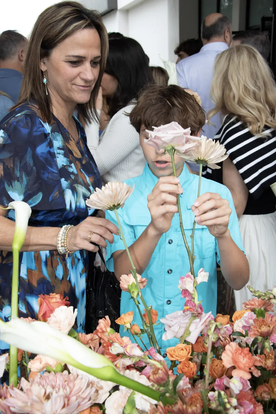 A mother and son choosing flower stems together at the truck